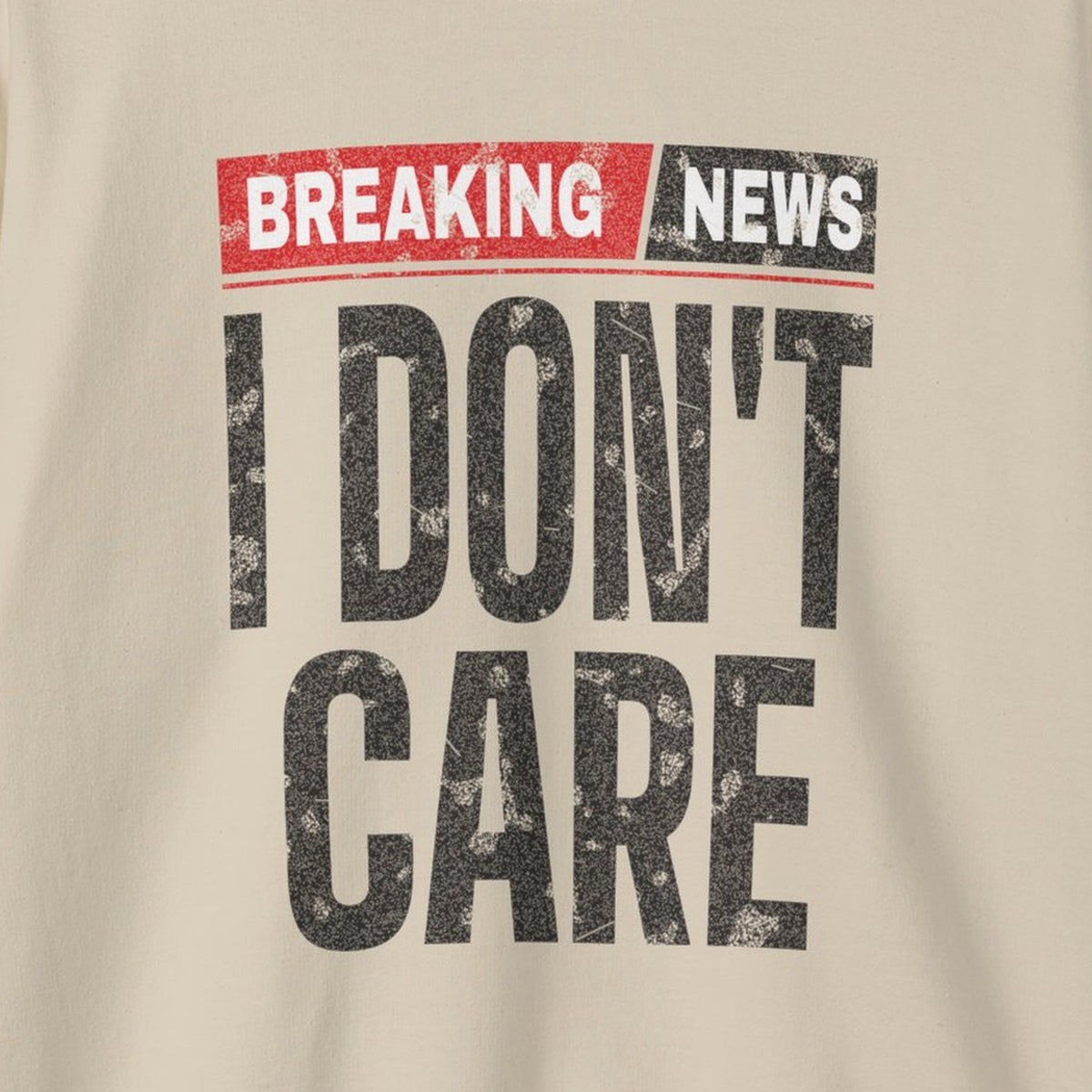 Breaking News I Don't Care Sweatshirt – Sand – front print close-up