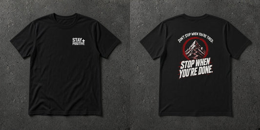 Black t-shirt with white Stay Positive chest logo and distressed white 'Don't Stop When You're Tired. Stop When You're Done.' back print with dark red accents – Stay Positive by The Hillbillies, front and back view