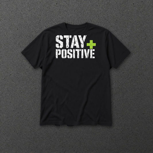 Stay Positive Logo tee Lime Plus – Black – front on grey concrete