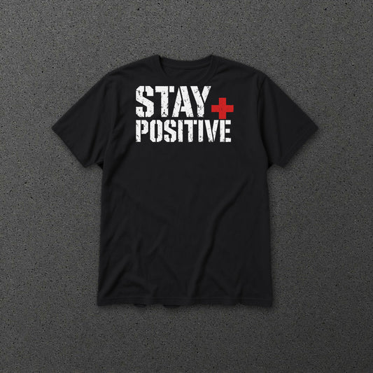 Stay Positive Logo tee Red Plus – Black – front on grey concrete