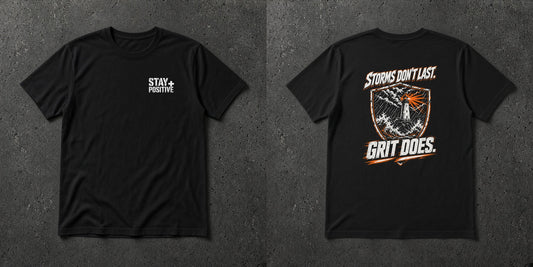 Black t-shirt with white Stay Positive chest logo and distressed white and safety orange lighthouse shield 'Storms Don't Last. Grit Does.' back print – Stay Positive by The Hillbillies, front and back view